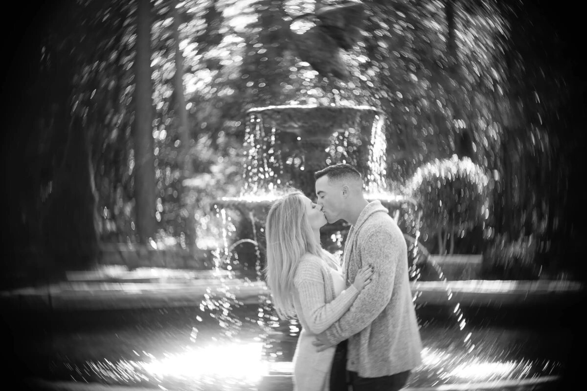 Couple kissing by a fountain