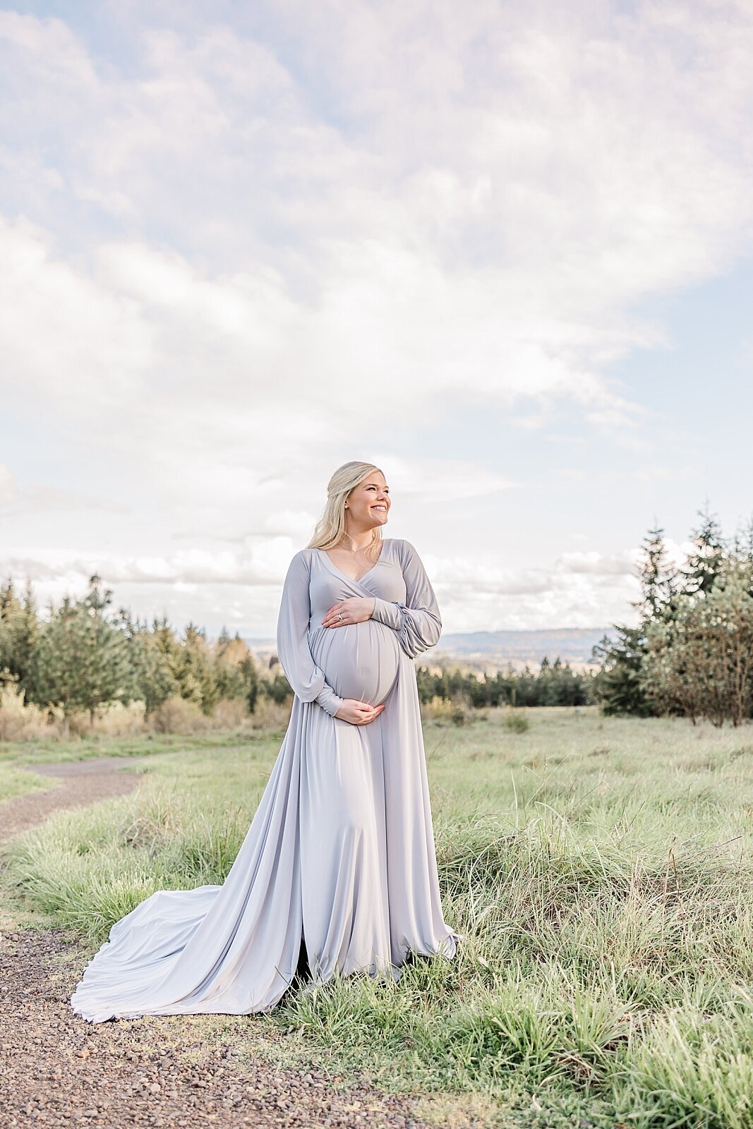 mom in silver dress holding baby belly