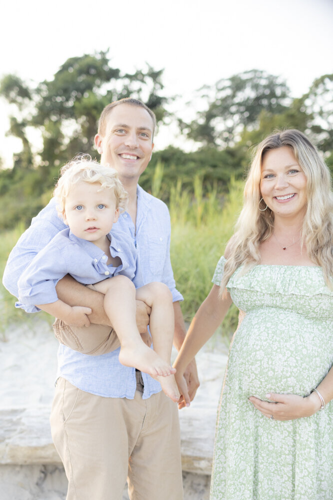 beach maternity photoshoot with young family