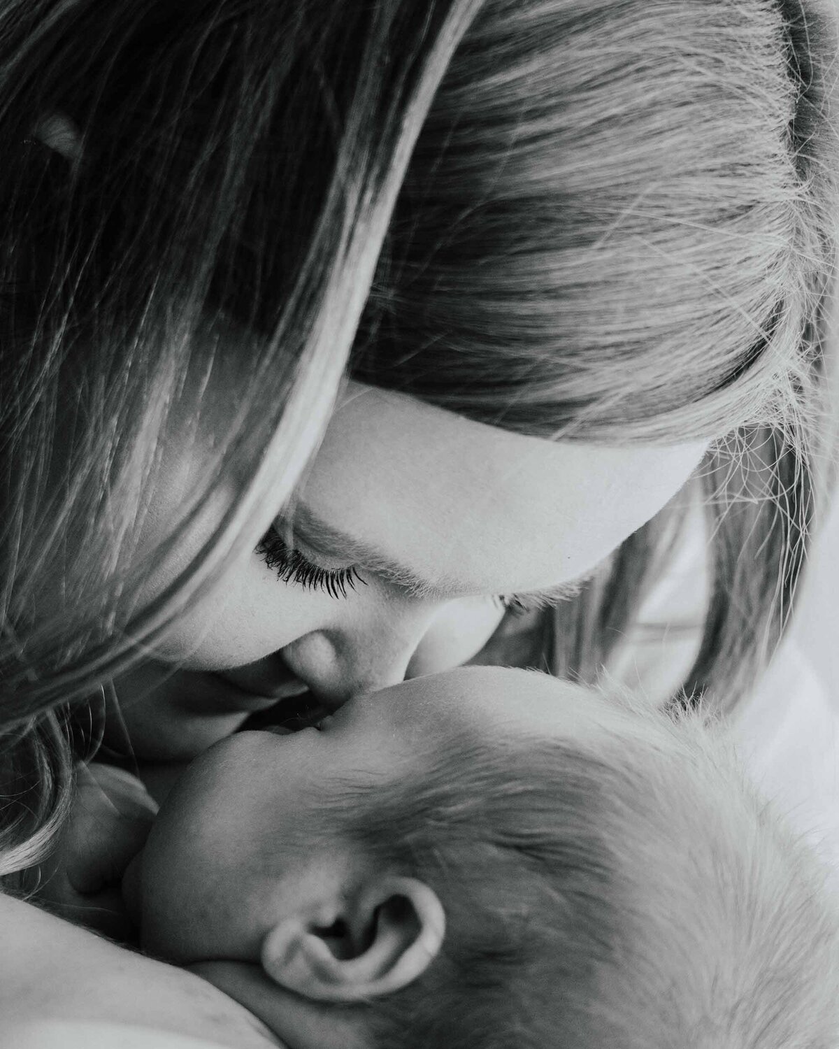 Maddie Rae Photography black and white close up of mom giving baby eskimo kisses