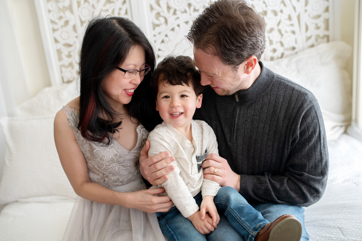 Family session of little boy and his parents in home