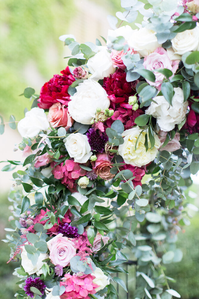 Pink and white ceremony flower arch