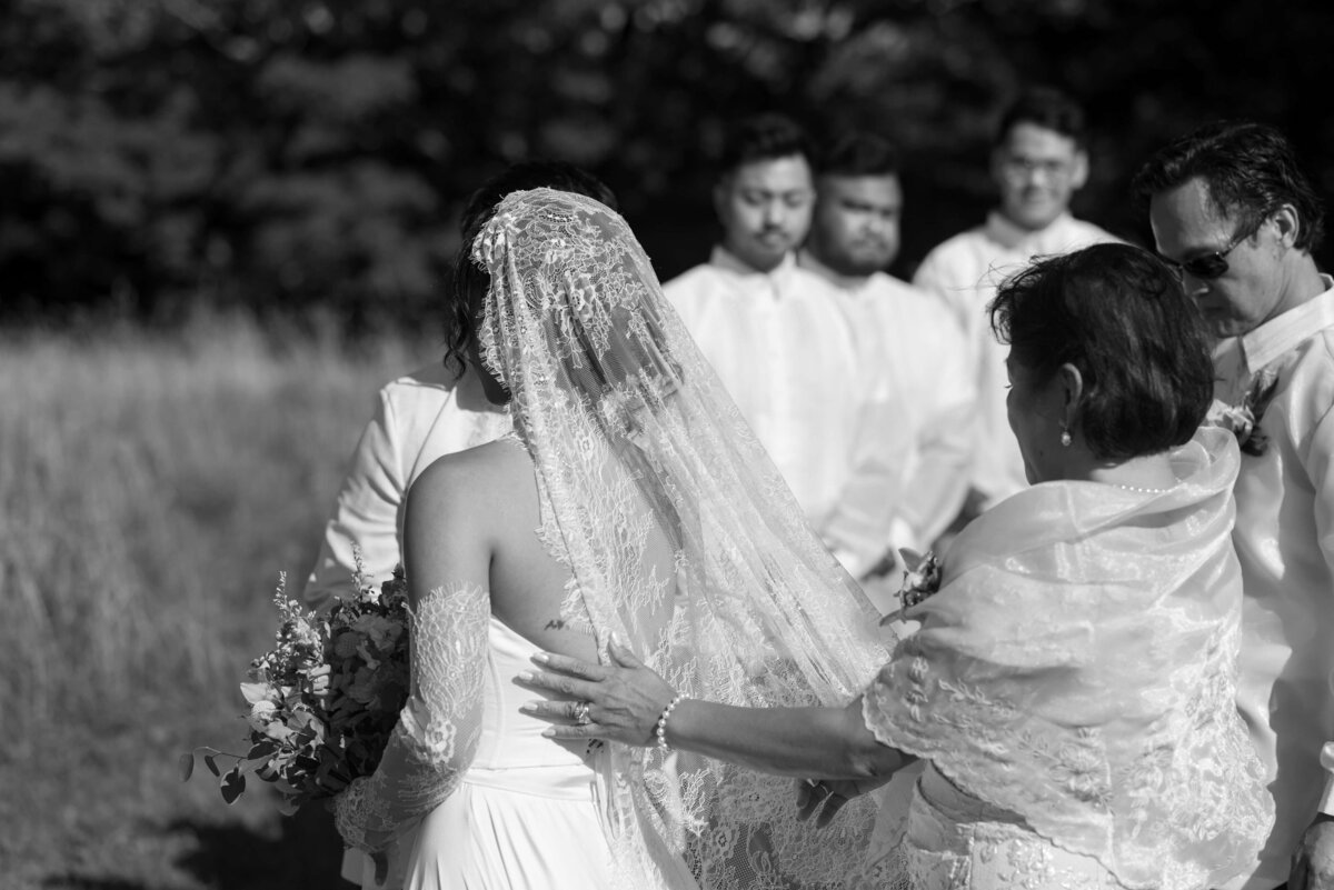 Bride having veil adjusted at Woodburn Ridge wedding, Nova Scotia