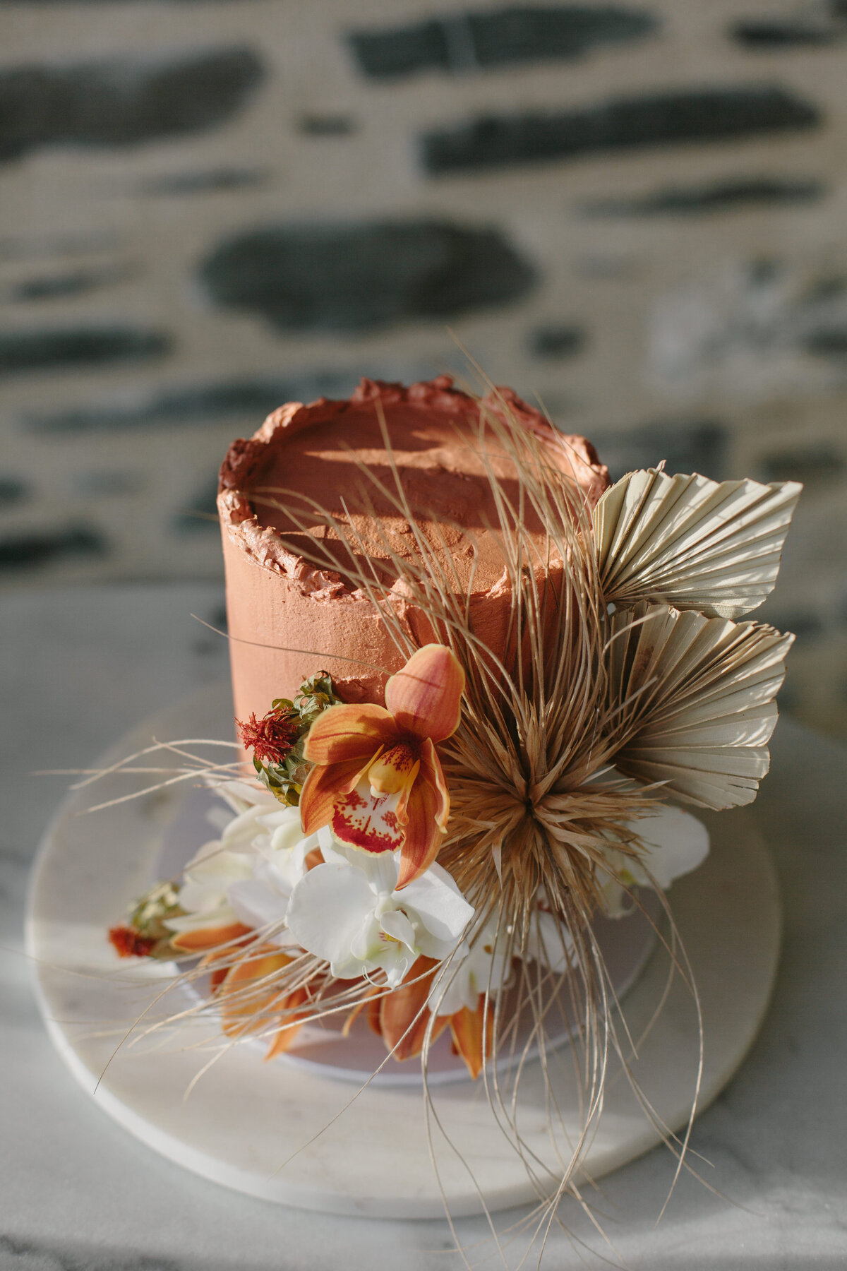 The Lovers Elopement Co - wedding cake adorned with matching flowers to bouquet