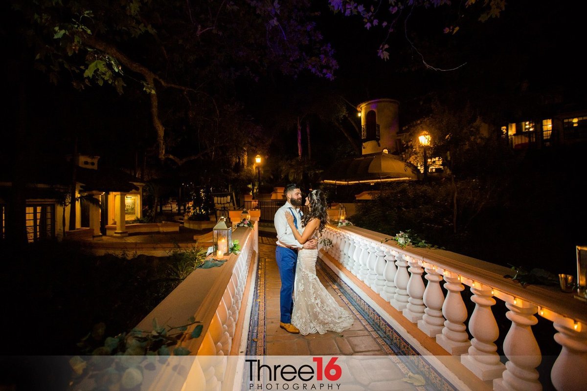 Night shot of the newly married couple on a bridge at Rancho Las Lomas