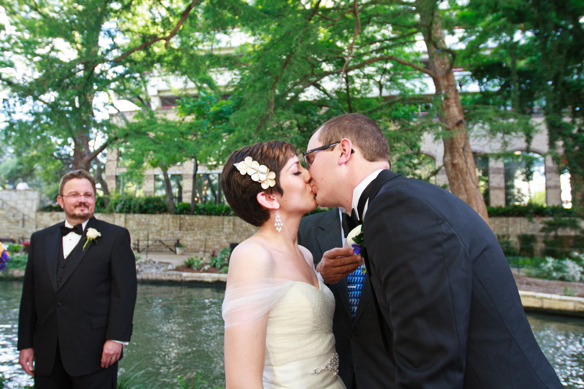 bride and groom kissing at wedding ceremony site downtown san antonio marriage island the contessa hotel riverwalk