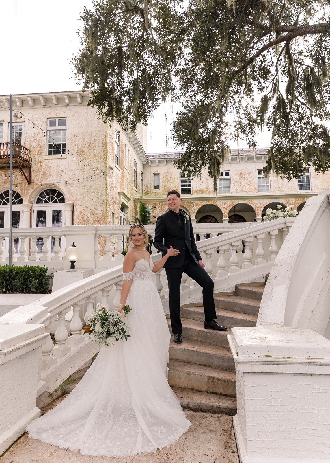 Groom and Bride walking up stairs at Bella Cosa, Lake Wales, Florida