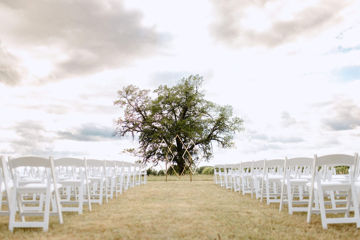 Outdoor East TX wedding ceremony set. up in open field at family farm