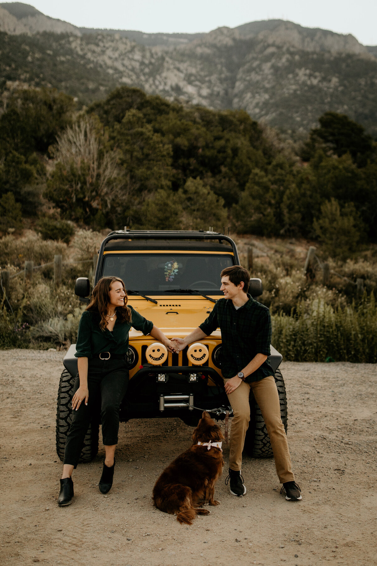 engaged couple with their jeep at the foothills in Albuquerque New Mexico