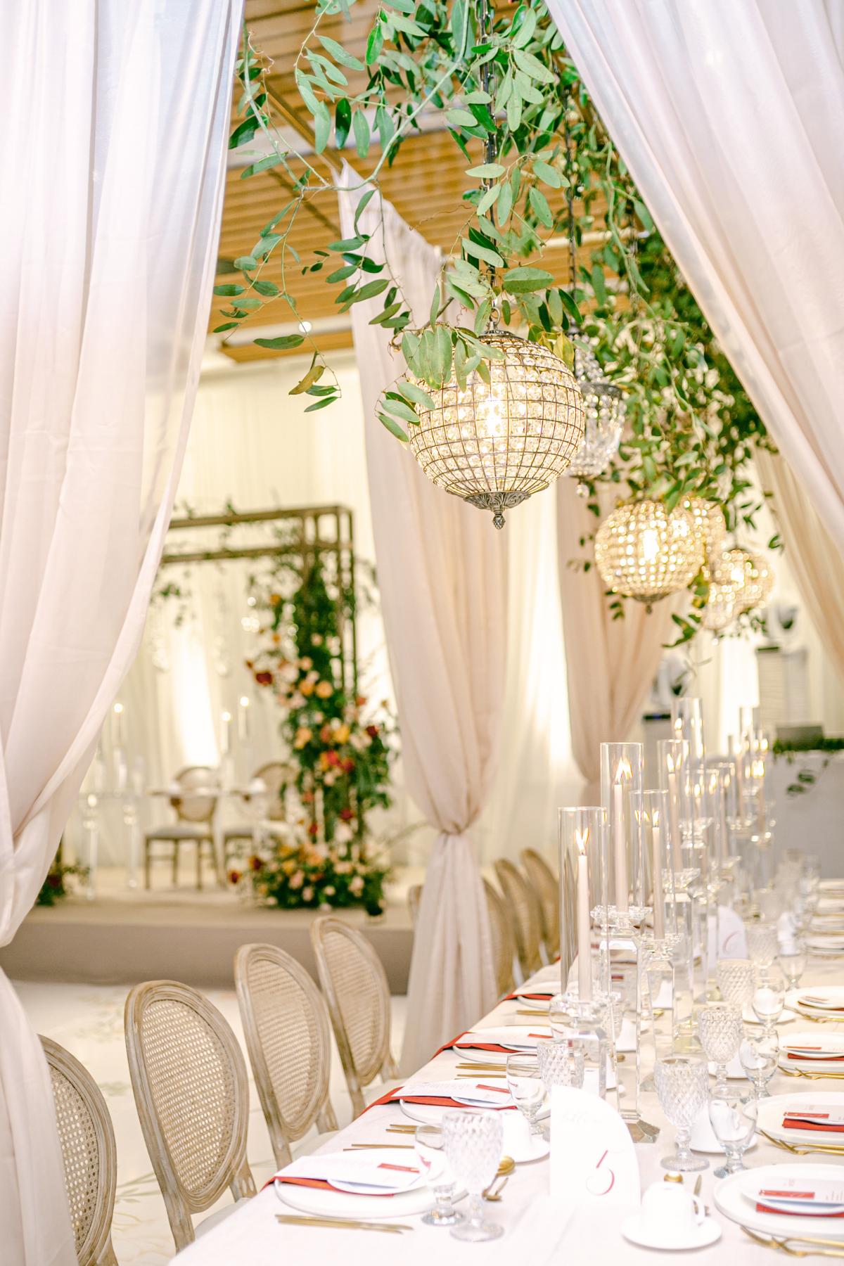 kavita-mohan-ivory-gold-orange-greenery-wedding-reception-sweetheart-table-draping-chandelier-cake