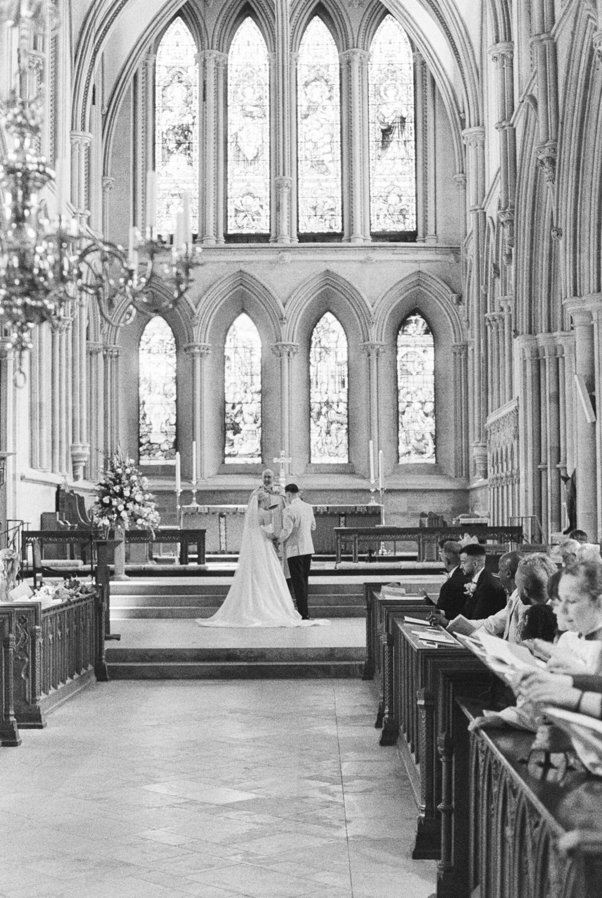 bride and groom during wedding ceremony at southwell cathedral captured on analog film camera