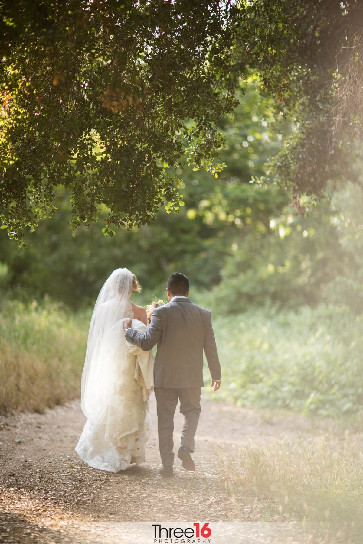 Bride and Groom go for a walk on a trail at the Vista Valley Country Club