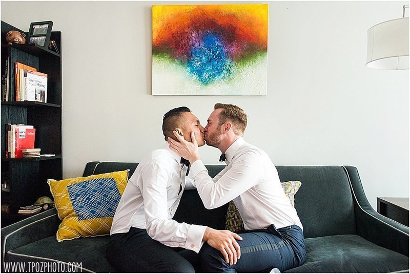 gay couple under a rainbow painting