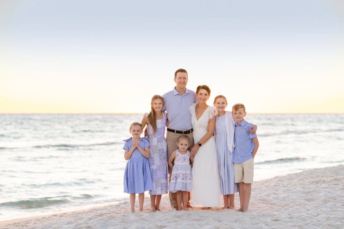 A large family with their arms around each other smiling