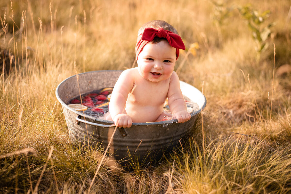 Smiling baby in fruit bath for family photography session in Toronto