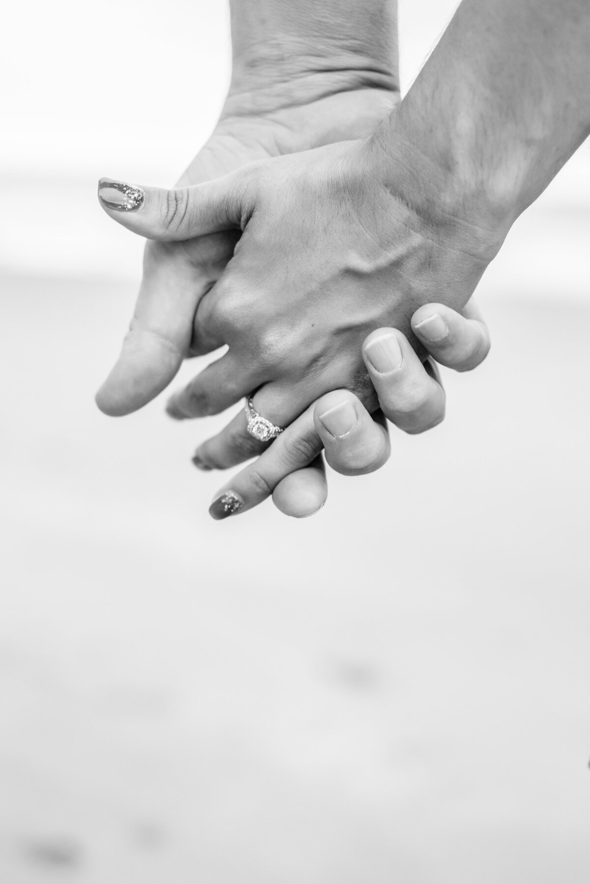 Engaged couple holding hands