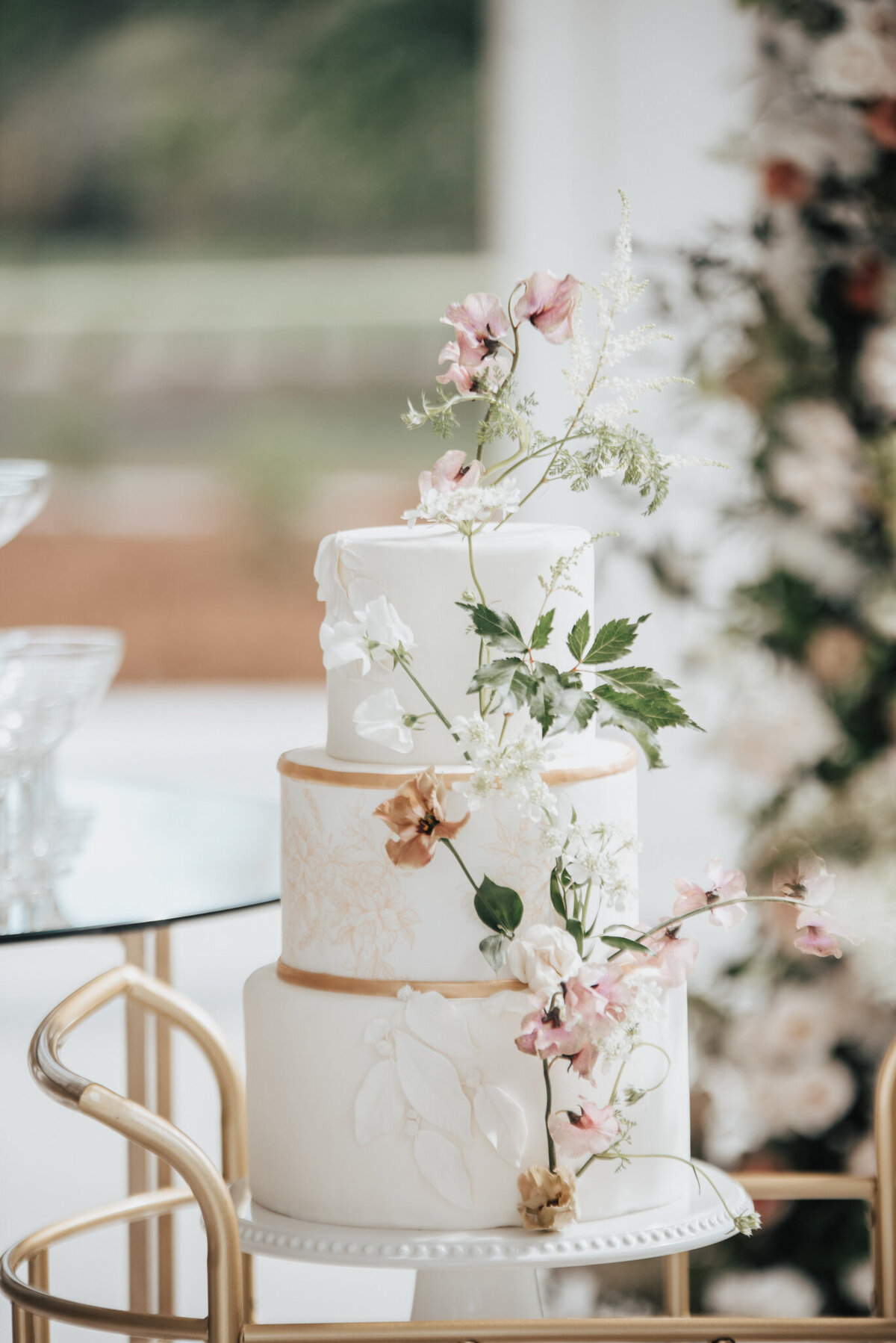 Gorgeous cake with white and pink by Calyx Floral Design, an innovative Red Deer, Alberta wedding florist, featured on the Brontë Bride Vendor Guide.