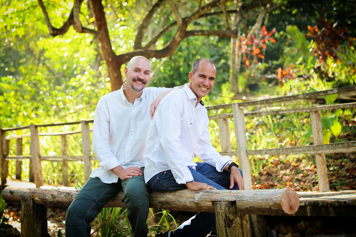 Two adult brothers sitting outdoors. Photo by Ross Photography, Trinidad, W.I..