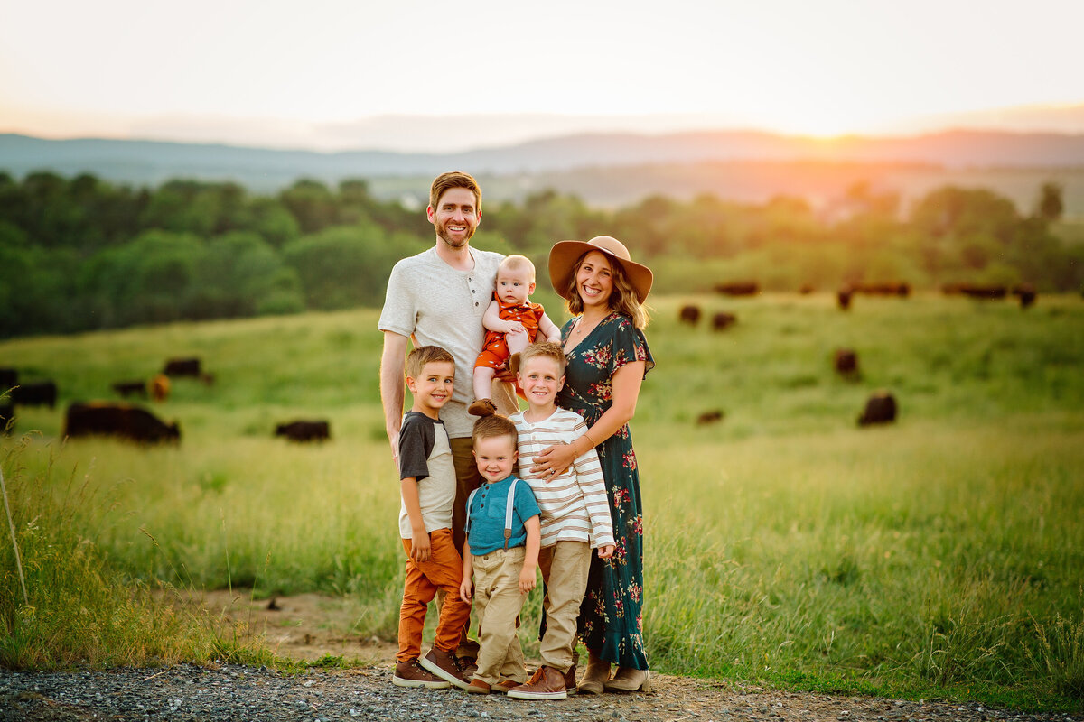 Family in a field at sunset with mountain views near Charlottesville, VA