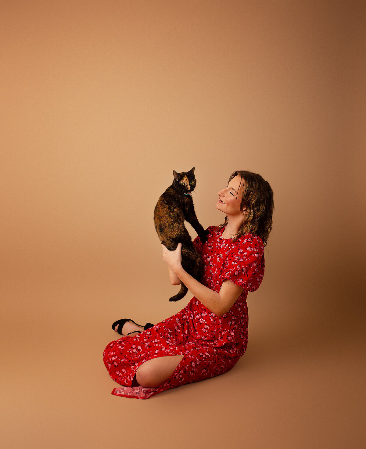 Studio senior session with cat and red dress