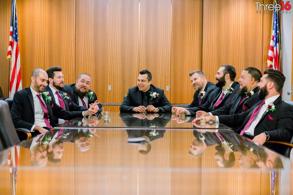 Groom and Groomsmen pose together having a board meeting
