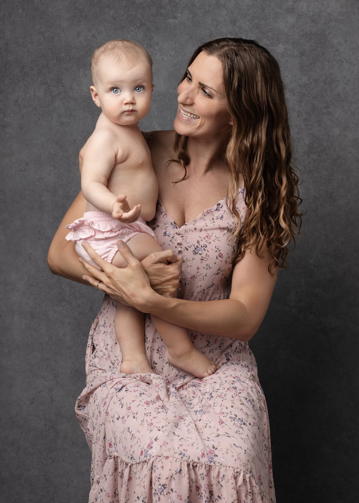 Mother-holding-baby-in-pink