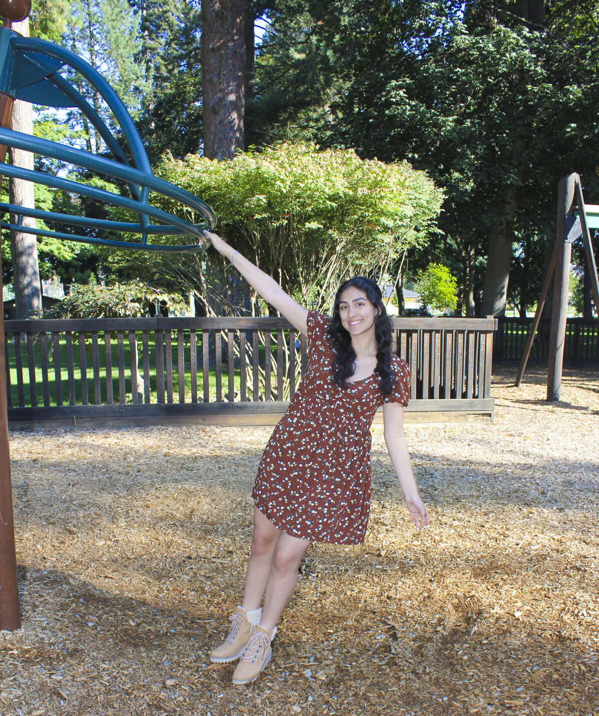 Young lady posing with park playground structure