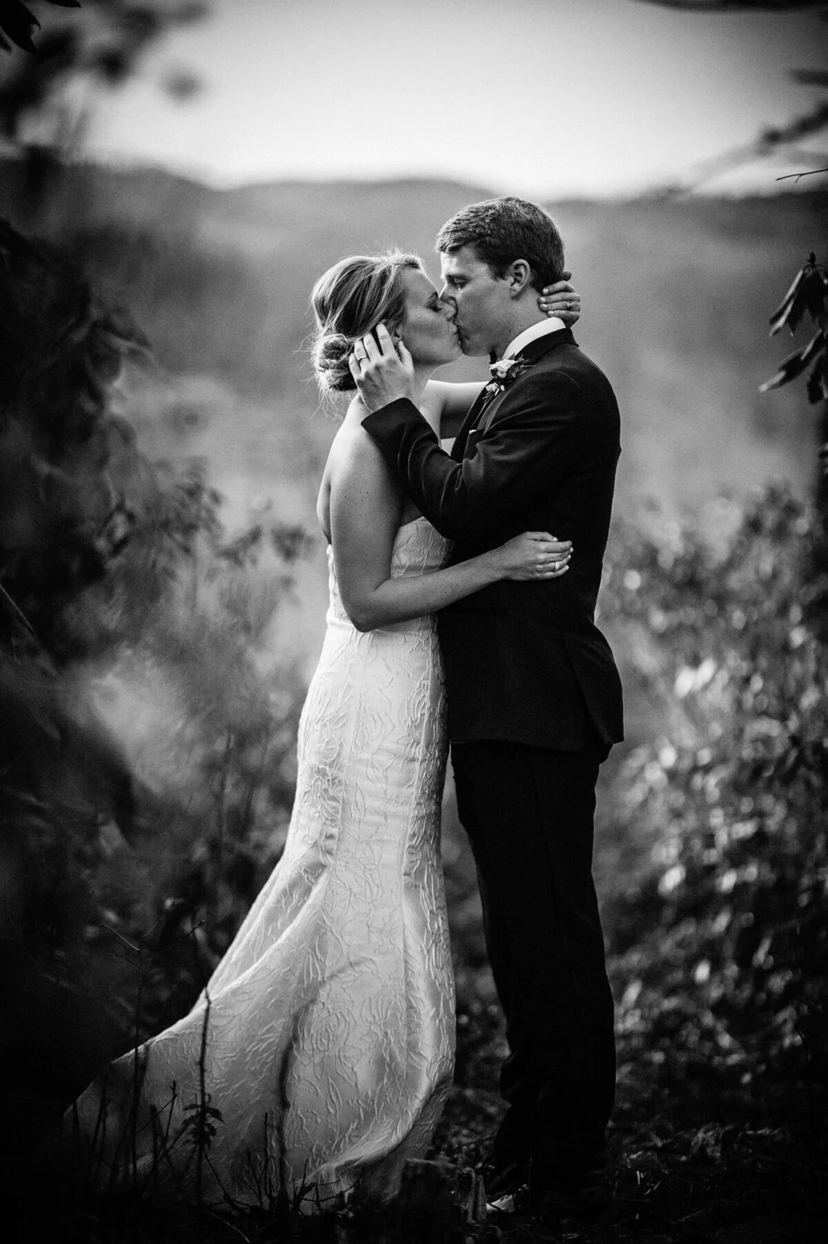 a wedding couple kissing in black and white.