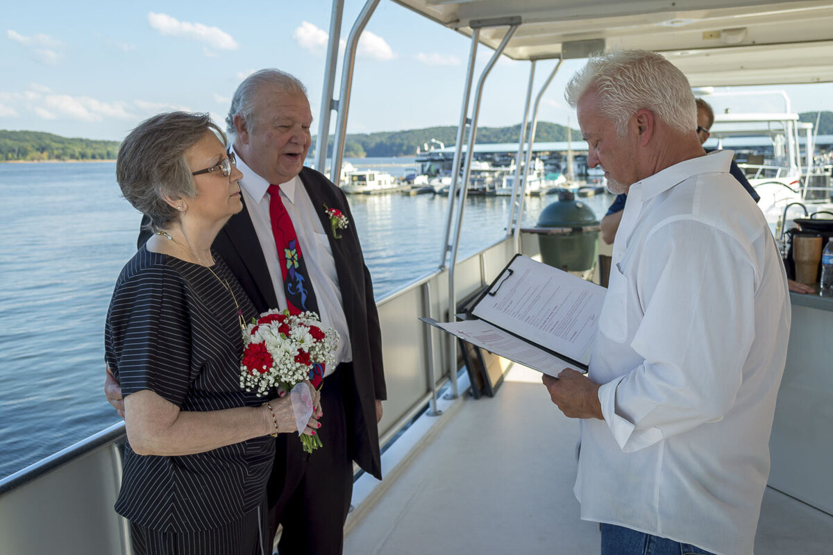 A couple gets married on a boat.