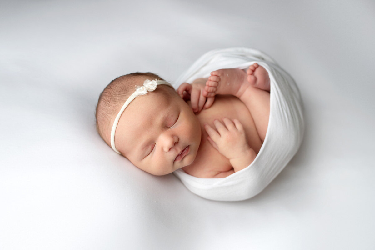 Newborn baby girl wearing a bow
