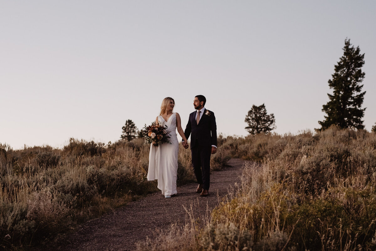 Photographers Jackson Hole capture bride and groom walking together