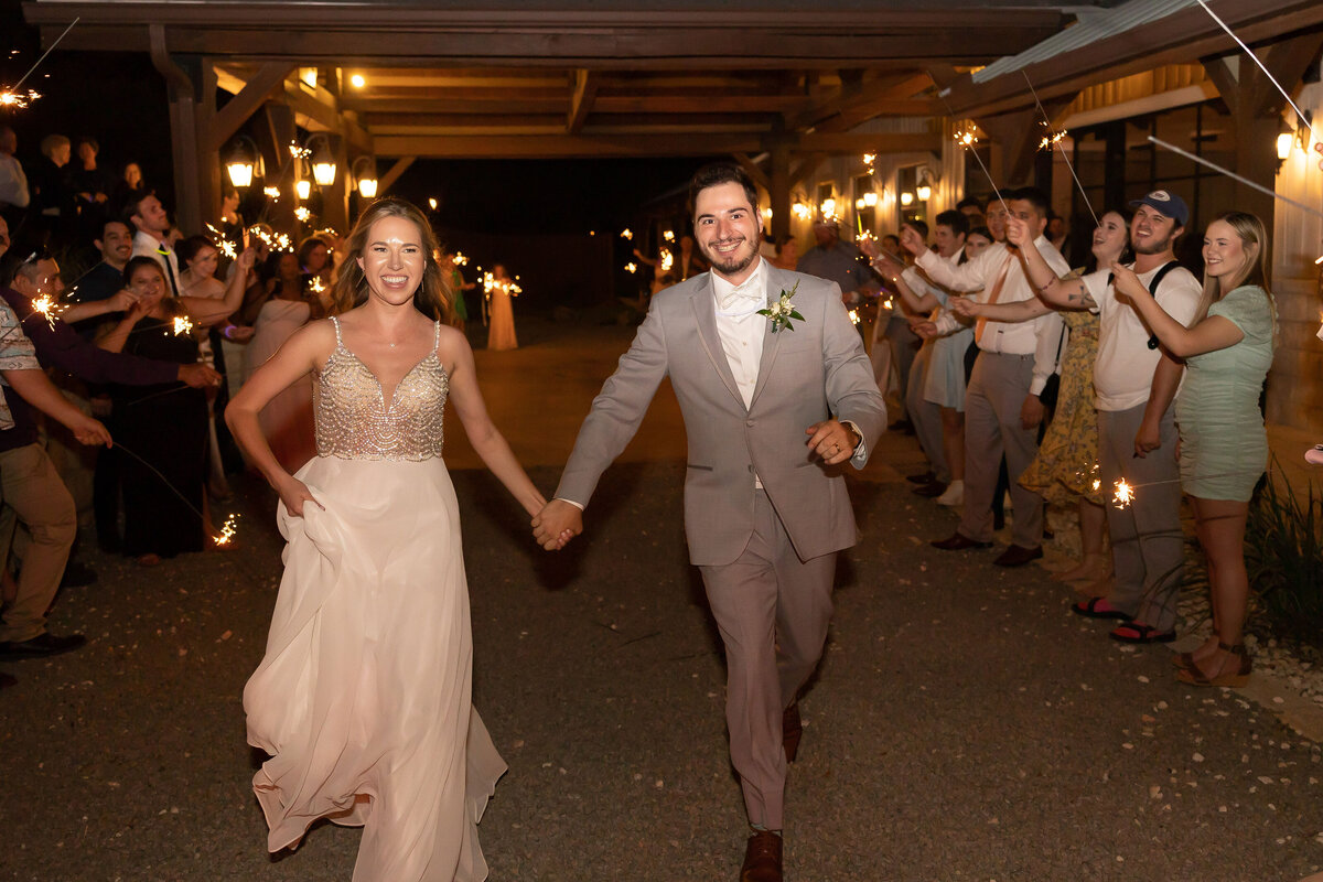 bride and groom run through sparkler exit at Milestone Georgetown Texas wedding