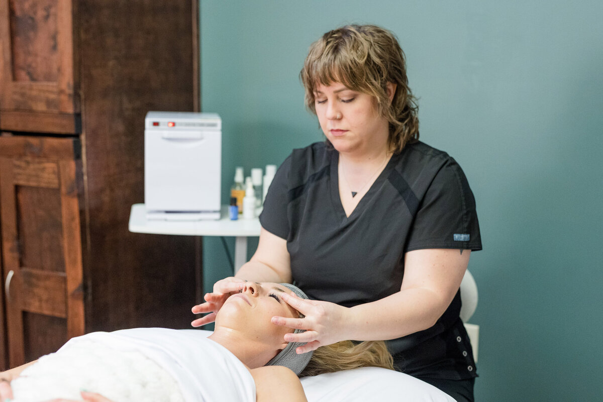 Woman laying on a table receiving a facial