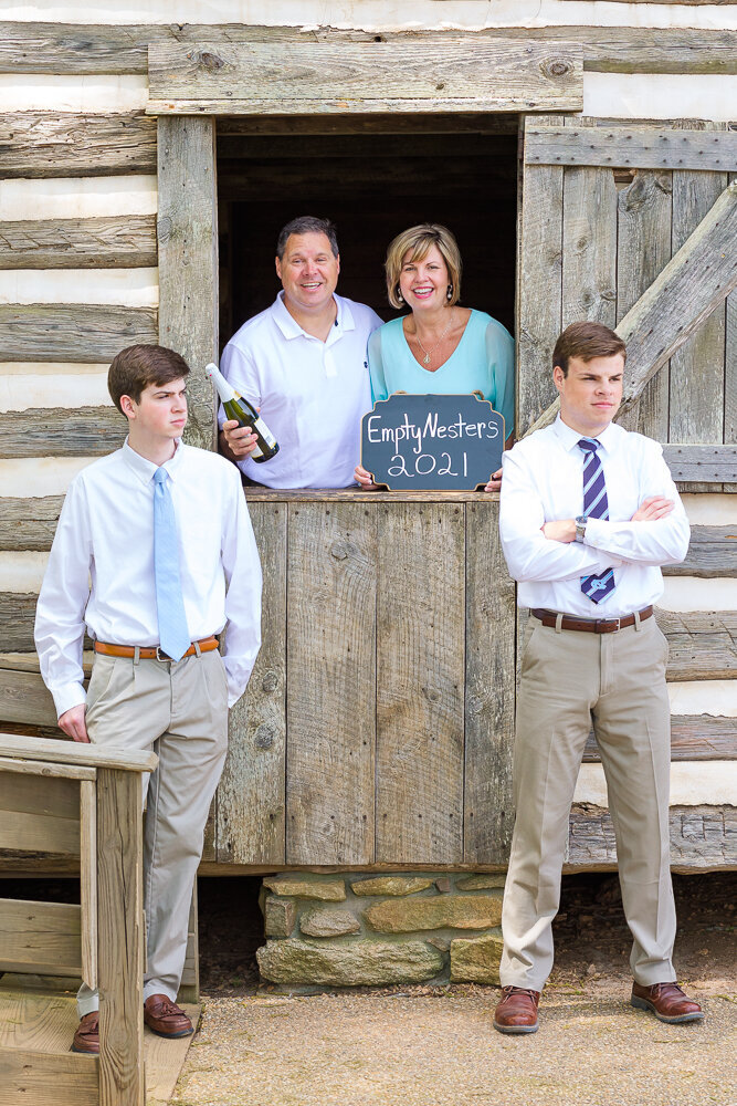 Outdoor family photo session with high school seniors in front of a old barn in Wake Forest, NC.