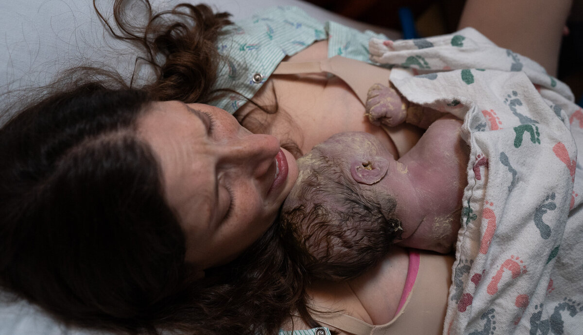 mother overcome with emotions as she holds her baby for the first time after giving birth