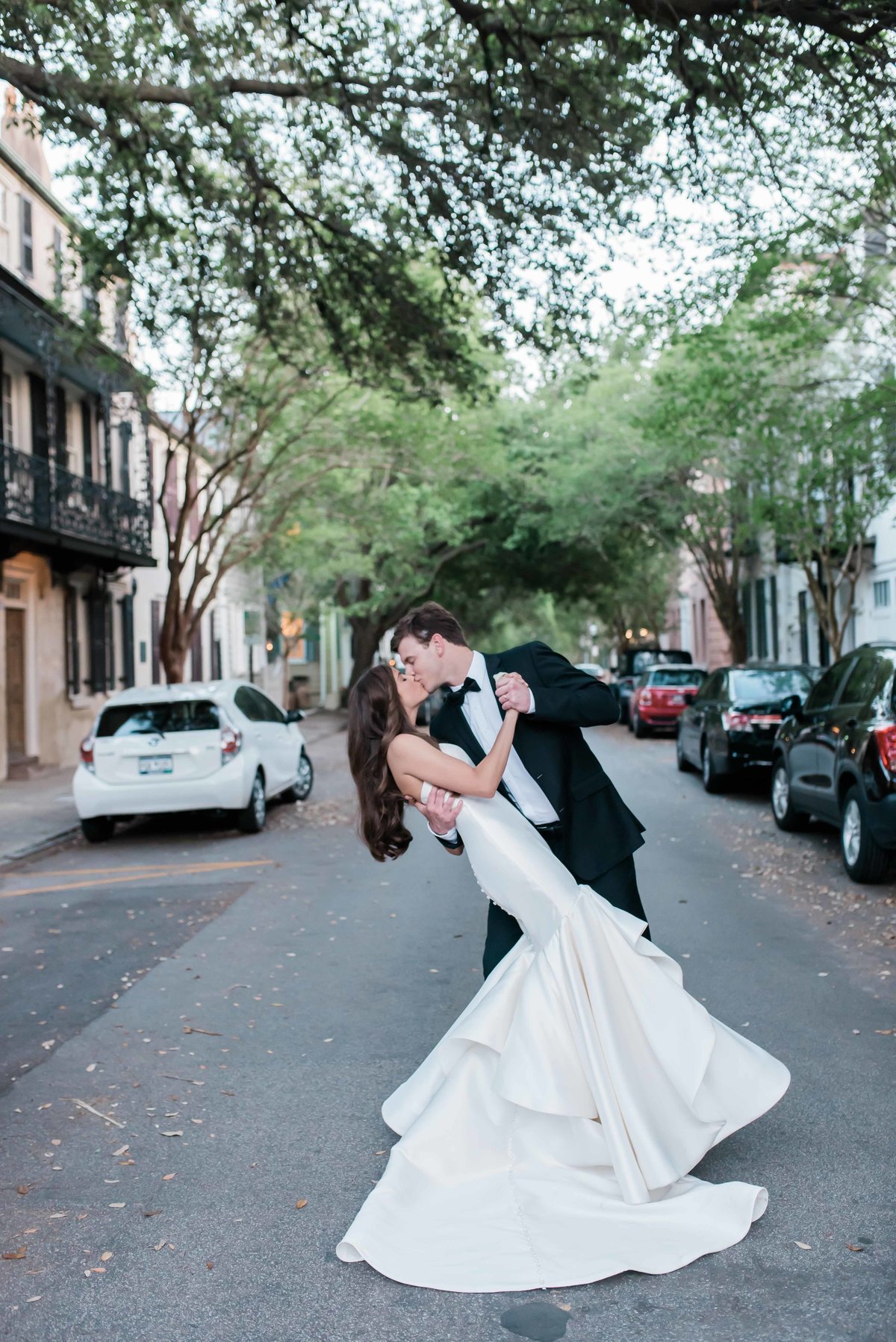 Bride and groom do a dip in the middle of the street in downtown Charleston, SC