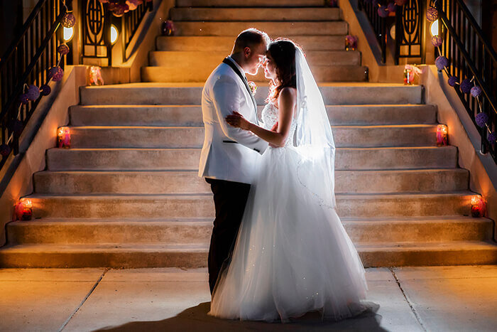 bride-groom-snuggle-stairs-lights