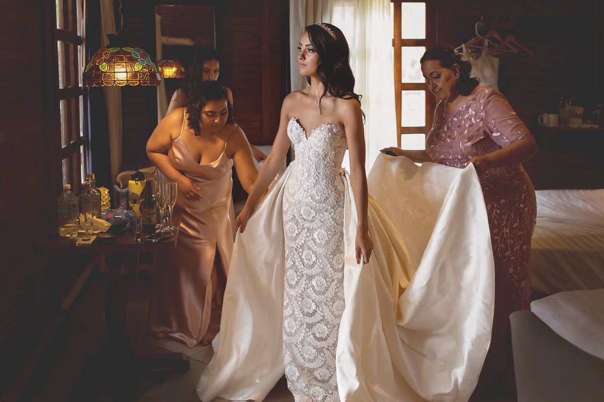 Bride with sister and mother getting ready at Riviera Maya wedding.