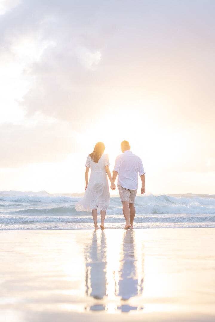 couple walking on the beach gold coast for their engagement photo session
