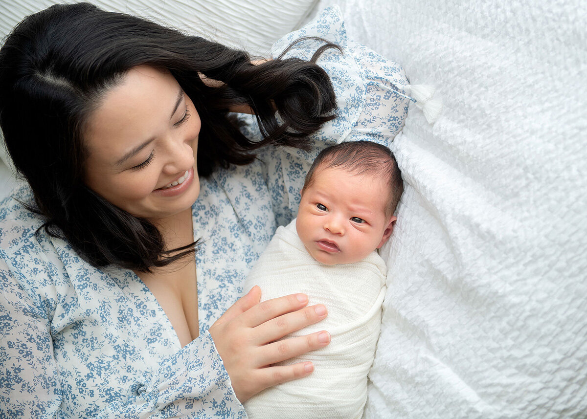 Newborn session with mother in floral dress