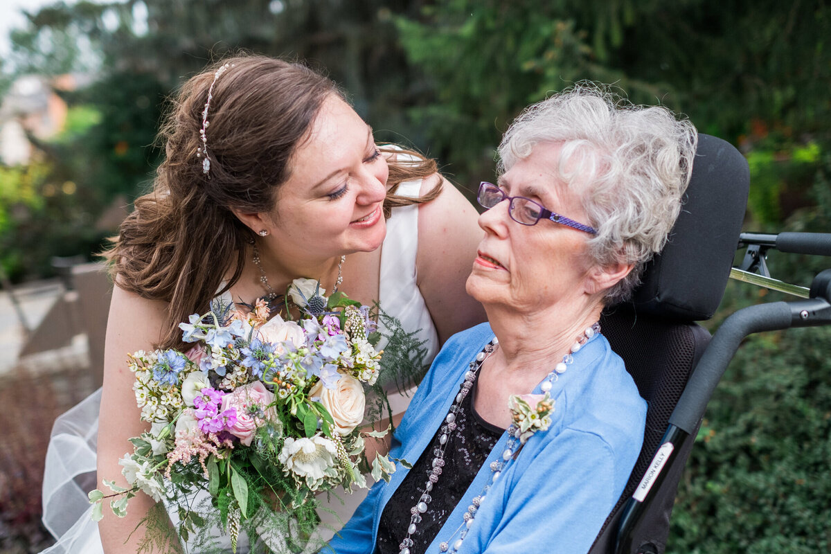 Bride-greeting-wheelchair-bound-mother--scaled
