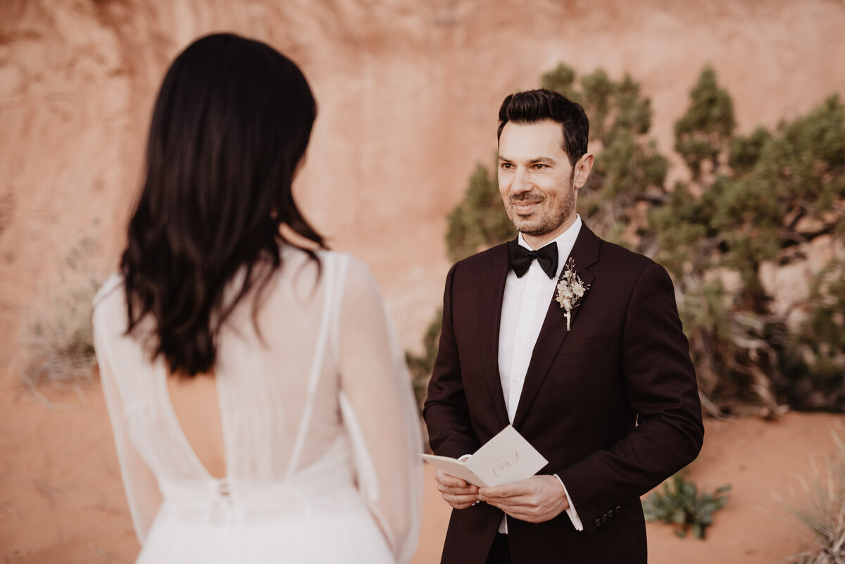 Utah elopement photographer captures groom reading vows to bride