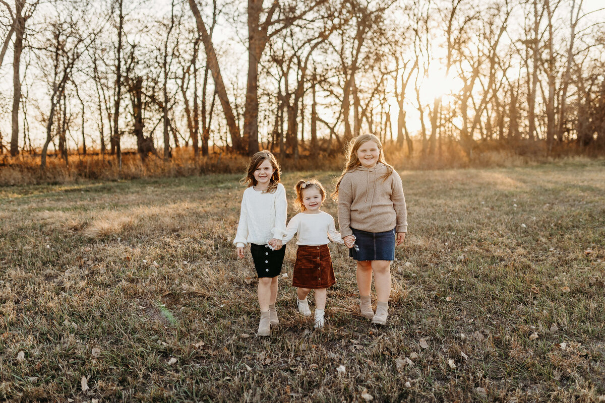 3 girls walking while holding in during the fall