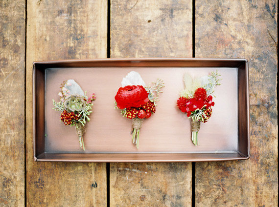 red boutonnieres rustic