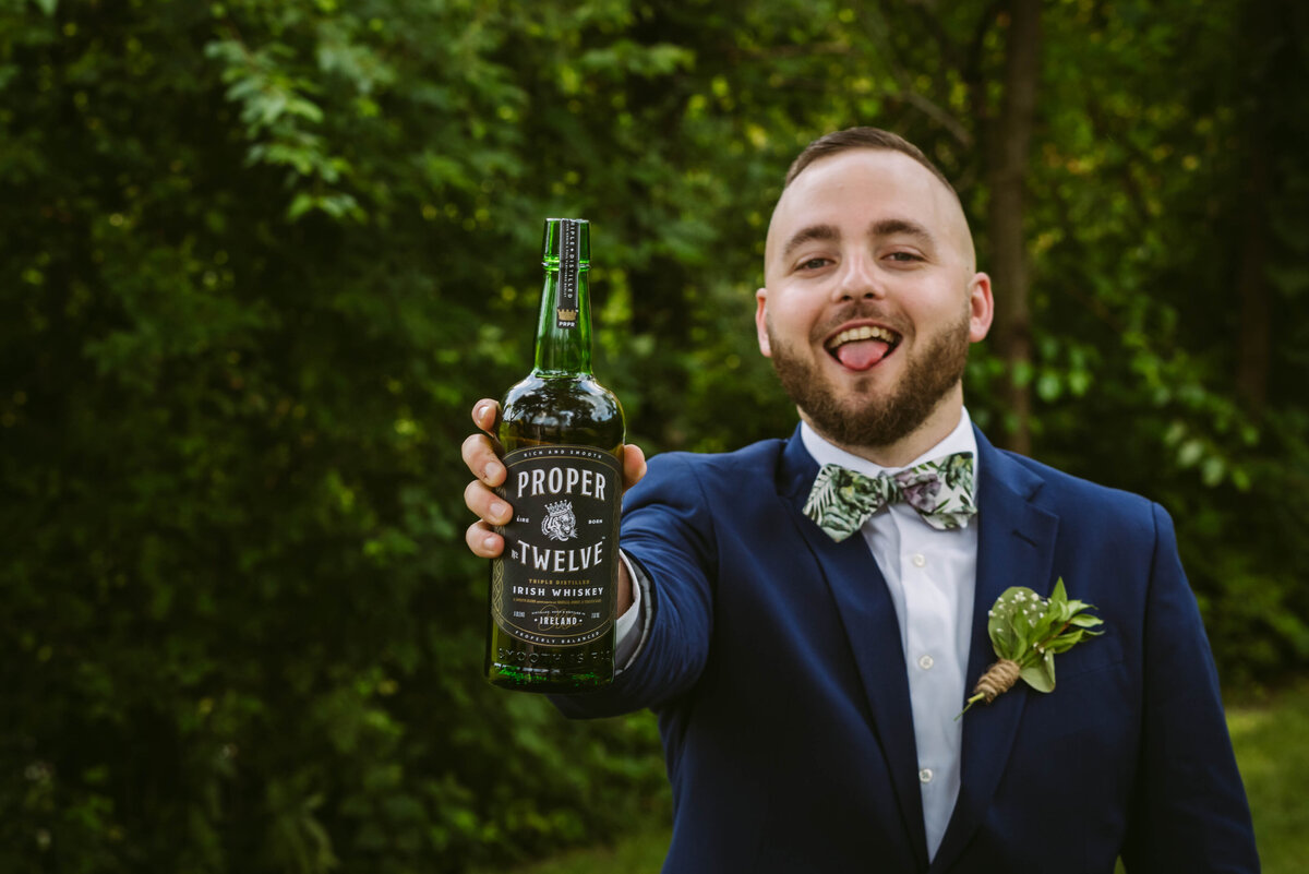 groom drinking at wedding