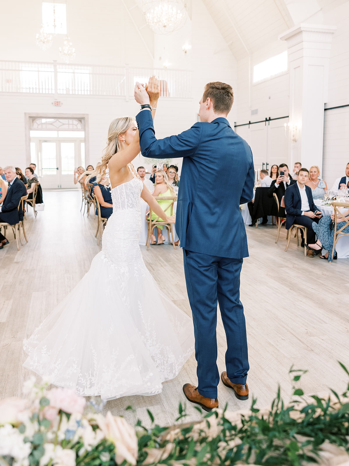 Groom spins his bride during their first dance as a married couple