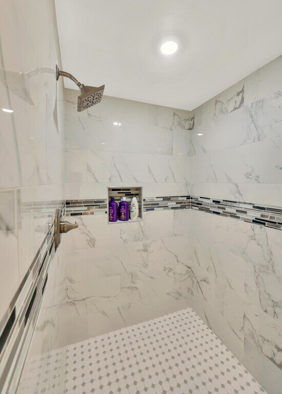 Large shower in the bathroom of this 2 bedroom, 2.5 bathroom luxury vacation rental loft condo for 8 guests with incredible downtown views, free parking, free wifi and professional decor in downtown Waco, TX.