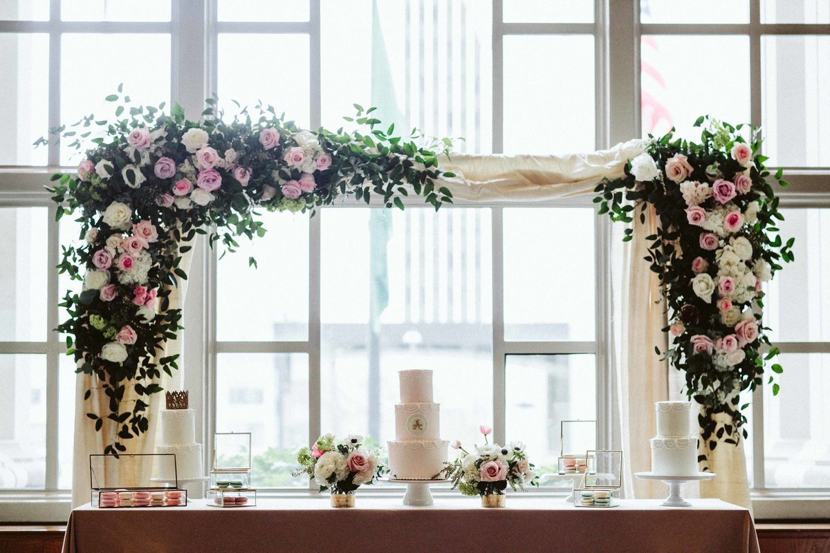 Garden party beautiful pink rose arch above cake table at Fairmont Olympic 1st birthday party