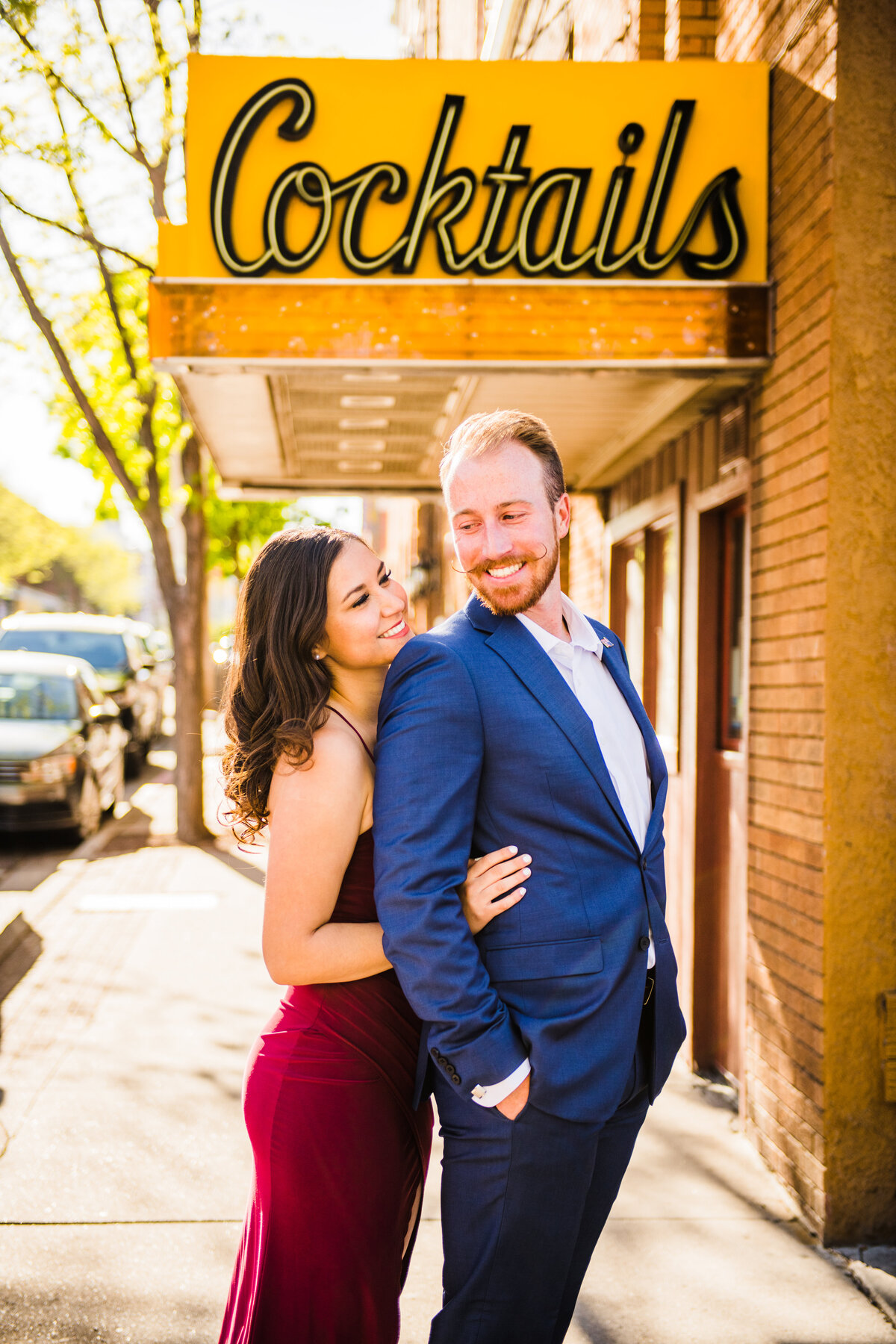 Engaged couple hugging downtown Flagstaff engagement photography