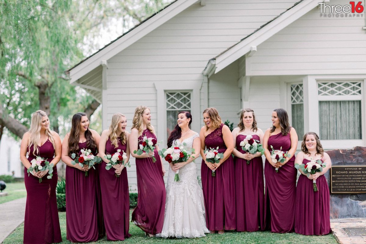 Bride and Bridesmaids share a laugh together during the photo session